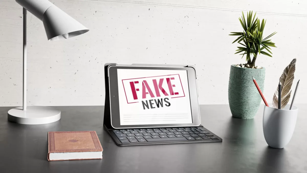 Desk with laptop fake news