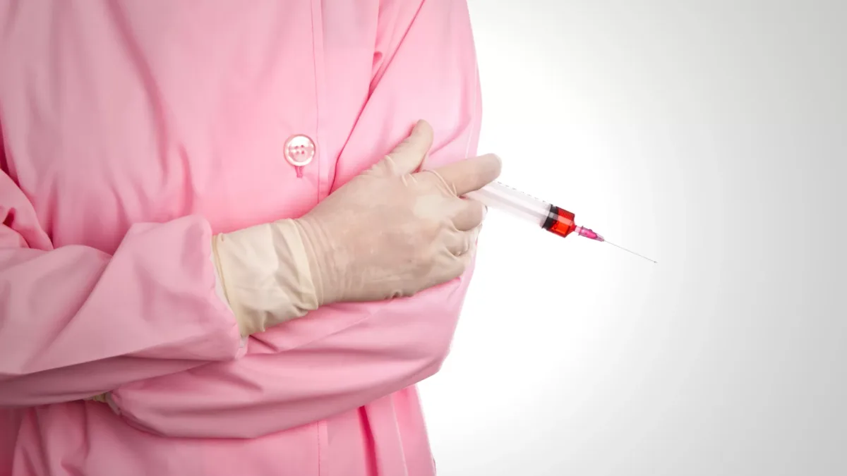 Hand of woman doctor with syringe